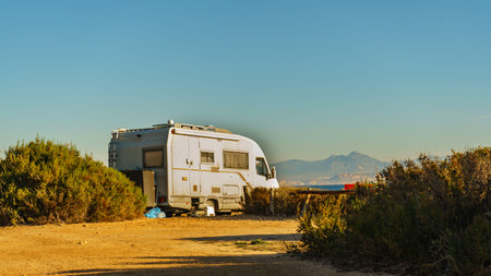 Camper, recreational vehicle on sea coast in Spain. Camping on nature beach. Holidays and traveling...