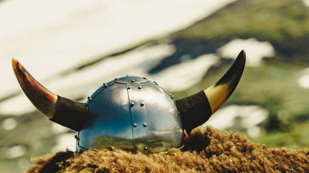 Viking helmet and brown fur on mountains nature in Norway. Tourism and traveling conceptの写真素材