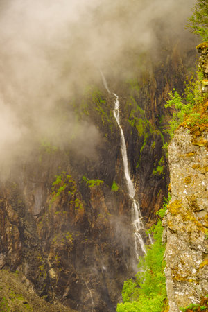 Voringsfossen waterfall, green summer mountains, Mabodalen canyon Norway. National tourist...