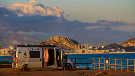 Alicante, Spain - December 5, 2019: Camper van wild camping on mediterranean coast near Alacant city on the Costa Blanca. Traveling by motorhome. Caravan vacation.のeditorial素材