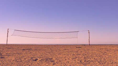 Volleyball summer sport equipment. Net netting wire on sandy beach outdoor. Active lifestyle.の写真素材