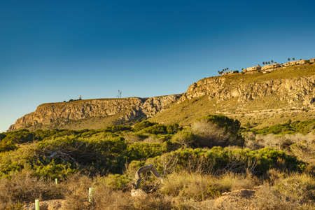 Spanish Costa Blanca coastline with houses building on cliff, Spain Alicante province, Santa Pola region.の写真素材