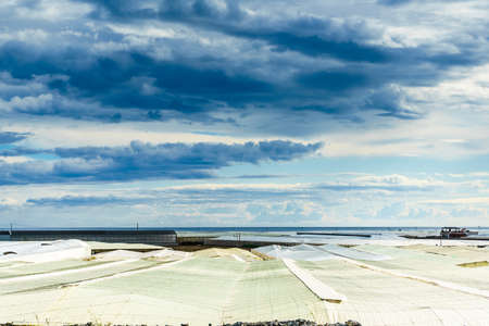 Spanish landscape and view of sea coast with many plastic greenhouses. Almeria region, Andalusia Spain.の写真素材