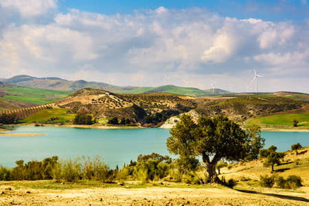 Spanish hills with wind turbines. Lake Embalse del Guadalhorce, Ardales Reservoir, Malaga Andalusia, Spainの写真素材