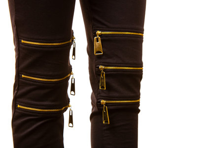 Unrecognizable fashionable woman wearing black skinny slim jeans with many zipper fasteners, grunge...