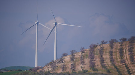 Wind turbines on hills. Power generator farm for renewable electric energy production near Ardales,...