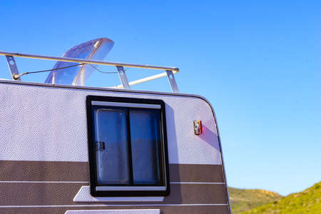 Sunroof, raisable panel window on roof top of rv caravan against blue sky. Travel with motor home vehicle.の写真素材