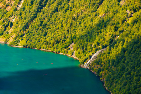 Tourism vacation and travel. Mountains fjord in Norway and people kayaking on water.の写真素材