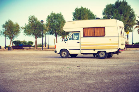 Camping on sea shore. Camper vehicle on beach, mediterranean coast in Spain.の写真素材