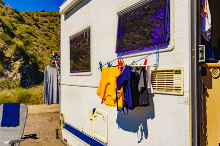 Wild camping on coastal nature. Camper car rv with clothes hanging to dry. Holidays with motor home.の写真素材