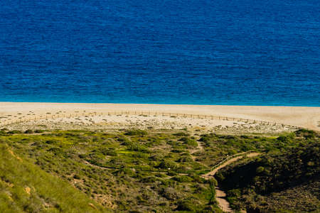 Coastal landscape, walking area path along sandy beach, Cabo de Gata Nijar Natural Park in Spainの写真素材