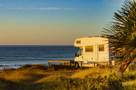 Camper car rv camping on beach sea shore, morning sun light. Spain Murcia region, Calblanque Regional Park.の写真素材