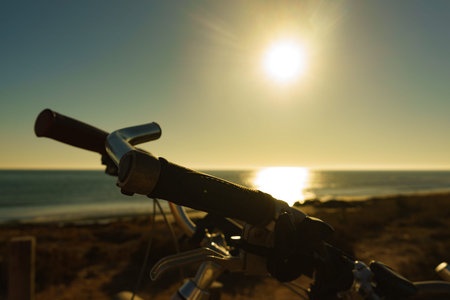 Bicycle outdoor on beach, morning time, sunup. Holidays, sport and recreation.