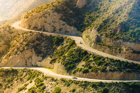 View from Granatilla Carboneras Viewpoint of hilly landscape and curved road. Cabo de Gata Natural Park, provincia Almeria, Spain.の写真素材