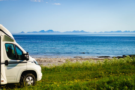 Camper car motor home on sea coast Gimsoysand beach in summer. Camping on ocean shore. Lofoten...