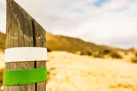 Green white trail hiking sign on mediterranean coast in Spainの写真素材