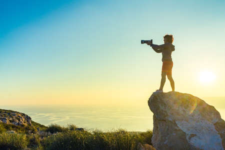 Female tourist traveller with camera taking travel picture from coastal spanish landscape, Mesa Roldan location, Andalusia Spain. Cabo de Gata Natural Park.の写真素材