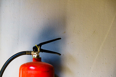 Fire extinguisher agains wall, copy space for text