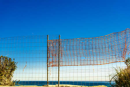 Volleyball summer sport equipment. Net netting wire on sandy beach outdoor. Active lifestyle.の写真素材
