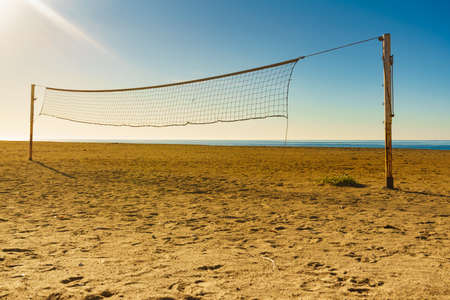 Volleyball summer sport equipment. Net netting wire on sandy beach outdoor. Active lifestyle.の写真素材