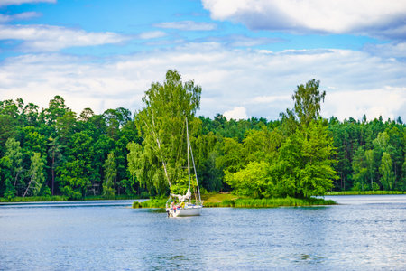 Boat yacht on lake during summer. Tuchola national park in Poland. Yachting, holidays concept.