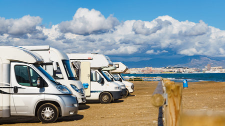 Caravan on mediterranean coast, Alicante city in the distance, Costa Blanca Spain. Wild camping on...