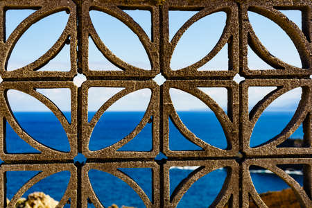 Concrete fence before sea. Coast in north Spain. View from Faro de Cabo Penas to the Bay of Biscay. Seascape of Atlantic ocean and Asturias coastline.の写真素材