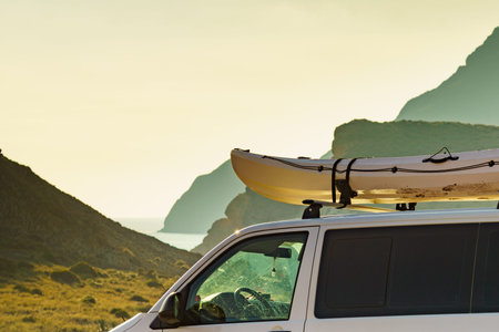 Car van with canoe on top roof against mountain nature. Cabo de Gata Nijar Natural Park, province...