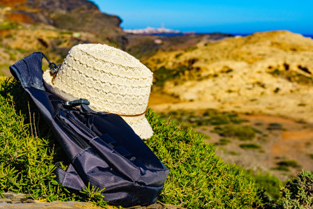 Hat and backpack, summer walking equipment on mediterranean sea coast. Murcia region, Calblanque...