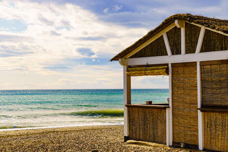 Sandy seashore with bamboo hut bar. Motril beach. Costa tropical, province Granada, Andalucia Spain.の写真素材