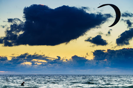Kiteboarding. kite surfer rides the waves. Sports activity. Kitesurfing action.