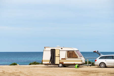 Caravan trailer camping on seashore. Vacation trip with mobile home.の写真素材