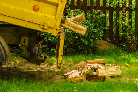 Truck is unloading firewood, throwing out wood logs. Preparation for winter.の写真素材