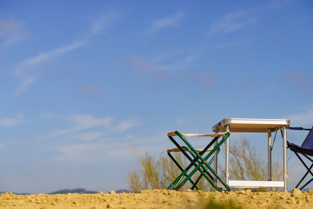 Empty folding camp chairs and table outdoor on nature. Holidays relaxation on trip.の写真素材