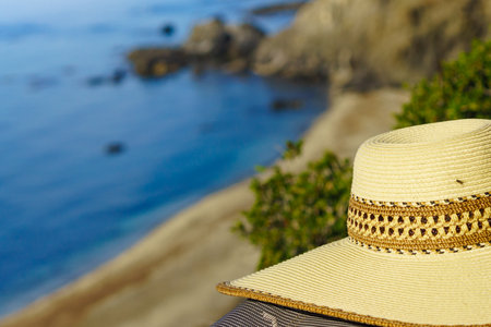 Summer hat against blue water, mediterranean sea coast.の写真素材