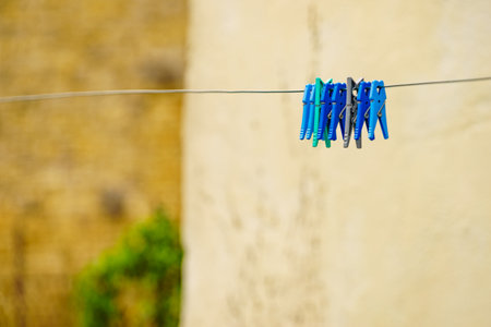 Clips for washing laundry clothes pegs on string rope outdoor. Housework conceptの写真素材
