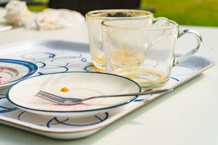 Dirty dishes after coffee drinking is finished. Camping on nature. Relax on fresh air in the garden.の写真素材