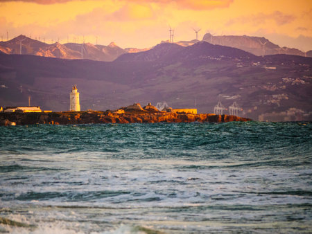 Coast landscape with Tarifa town on skyline and wind turbines in mountains. Costa de la Luz, province of Cadiz, Andalusia in Spain.の写真素材