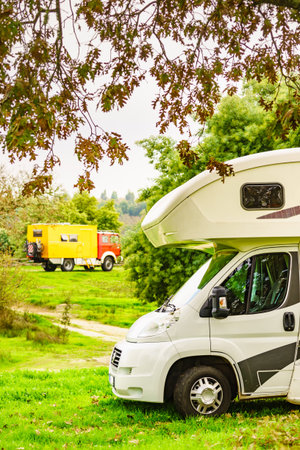 Caravan and off road camper, 4x4 rv motor home camping on nature. holiday trip.の写真素材
