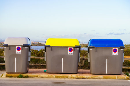 Industrial big garbage bins outdoors on coastal parking placeの写真素材