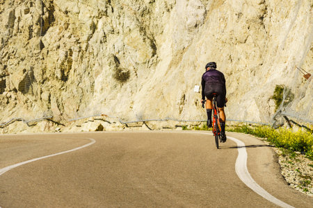 Cyclist on road. Cabo de Gata Park, Almeria province, Spain.