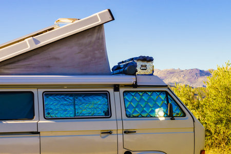 Camper van with roof top tent and thermal window screen camping on nature. Holidays trips and vanlife.の写真素材