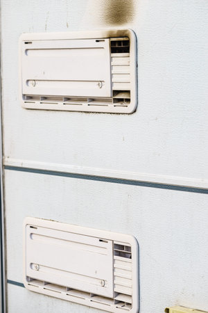 Camper car detail. Grid, fridge ventilation plate blackened by smoke. Gas problem.
