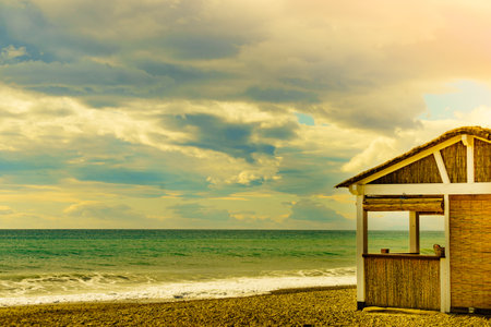 Sandy seashore with bamboo hut bar. Motril beach. Costa tropical, province Granada, Andalucia Spain.の写真素材