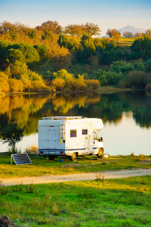 Caravan with portable solar panel camping on autumn nature in Portugal.の写真素材