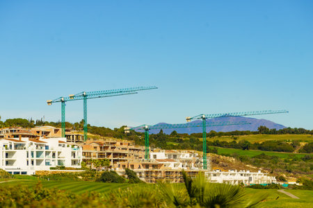 Spanish coastal landscape with construction site with crane industrial equipment. Building activities.の写真素材