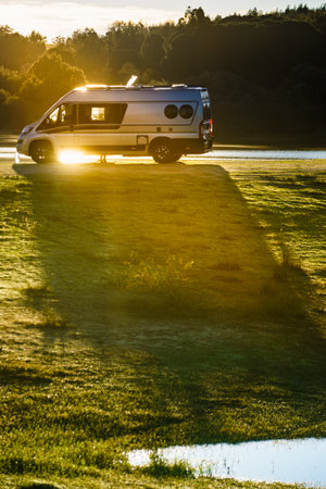 Camper van camping on nature. Travel in motor home.の写真素材