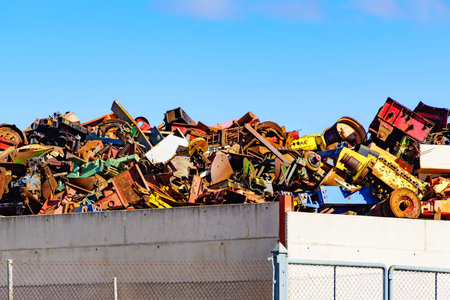Huge pile of scrap metal junk garbage with blue sky background