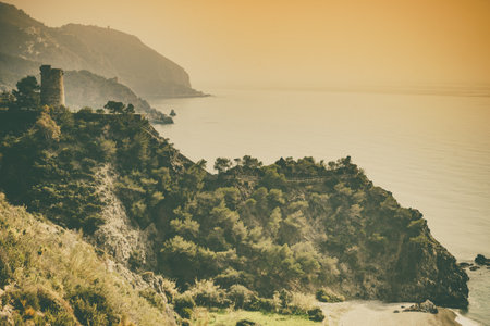 Coastal landscape with old tower. Torre Del Pino, Pine tower on cliffs of Maro Cerro Gordo Natural Park, Malaga province, Costa Del Sol, Andalusia in Spain.の写真素材