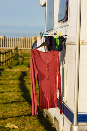 Wild camping on nature. Camper car rv with clothes hanging to dry. Holidays with motor home.の写真素材